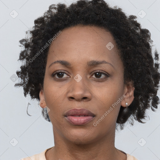 Joyful black adult female with short  brown hair and brown eyes