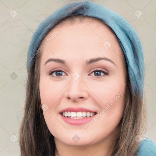 Joyful white young-adult female with long  brown hair and blue eyes