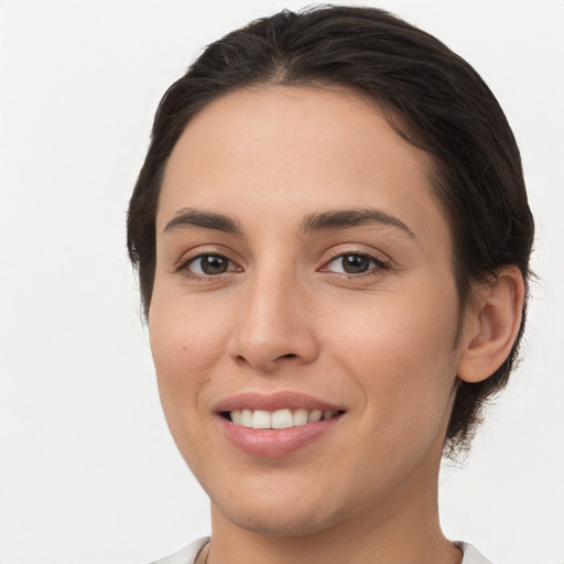 Joyful white young-adult female with medium  brown hair and brown eyes