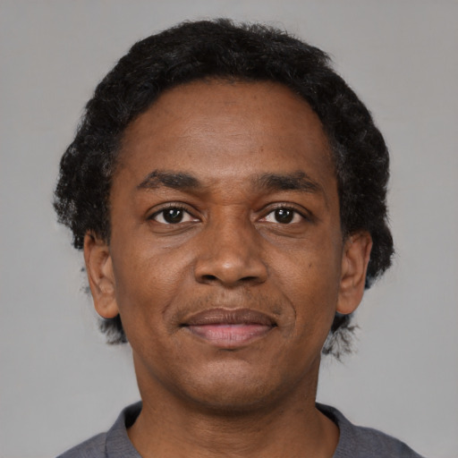 Neutral black adult male with short  black hair and brown eyes