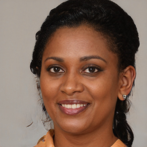 Joyful black young-adult female with medium  brown hair and brown eyes