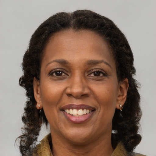 Joyful black adult female with medium  brown hair and brown eyes