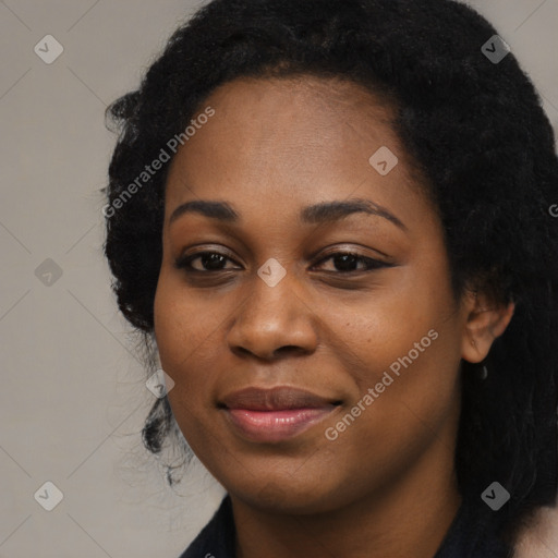 Joyful black young-adult female with long  black hair and brown eyes