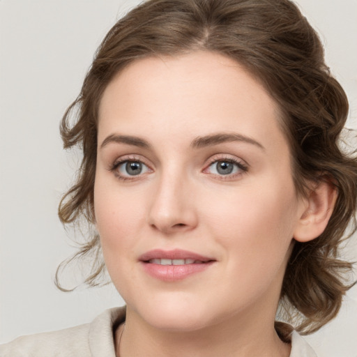 Joyful white young-adult female with medium  brown hair and blue eyes