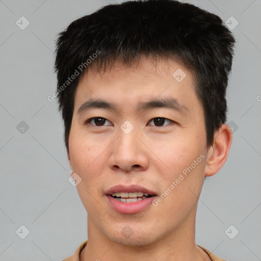 Joyful asian young-adult male with short  brown hair and brown eyes