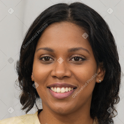 Joyful black young-adult female with long  brown hair and brown eyes