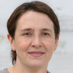 Joyful white adult female with short  brown hair and grey eyes