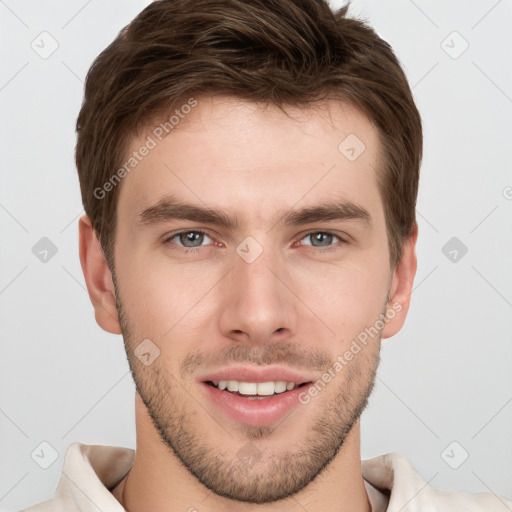 Joyful white young-adult male with short  brown hair and grey eyes