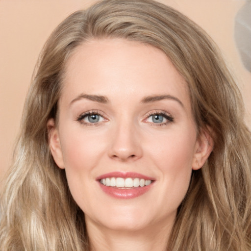 Joyful white young-adult female with long  brown hair and green eyes