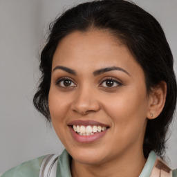 Joyful latino young-adult female with medium  brown hair and brown eyes