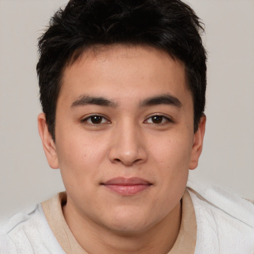 Joyful asian young-adult male with short  brown hair and brown eyes