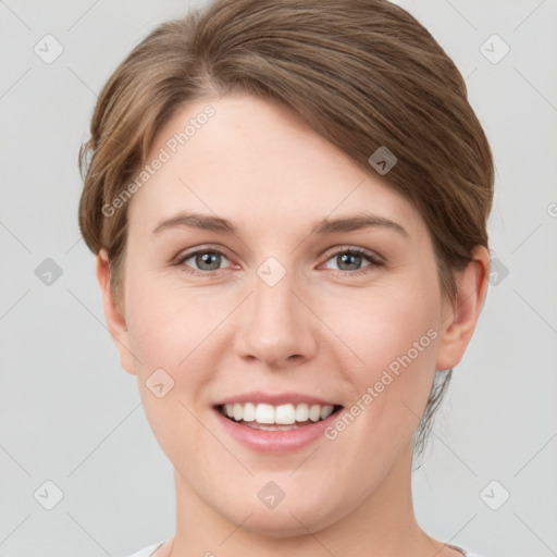 Joyful white young-adult female with short  brown hair and grey eyes