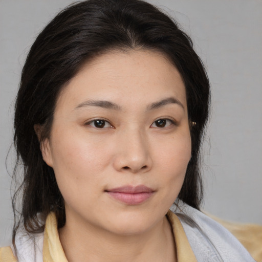 Joyful white young-adult female with medium  brown hair and brown eyes