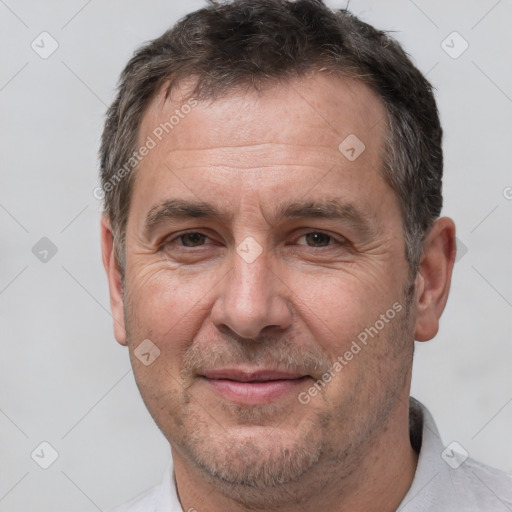 Joyful white adult male with short  brown hair and brown eyes