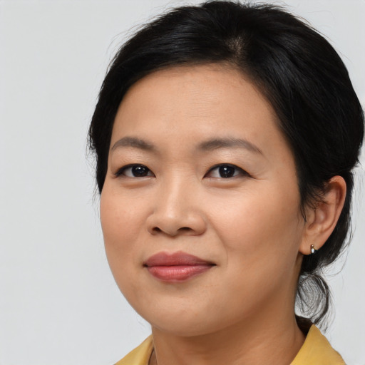 Joyful asian young-adult female with medium  brown hair and brown eyes