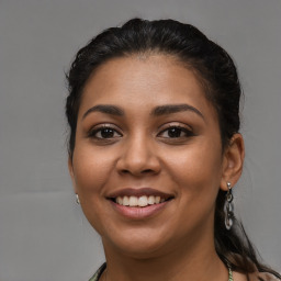 Joyful latino young-adult female with long  brown hair and brown eyes