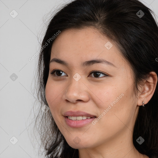 Joyful asian young-adult female with long  brown hair and brown eyes