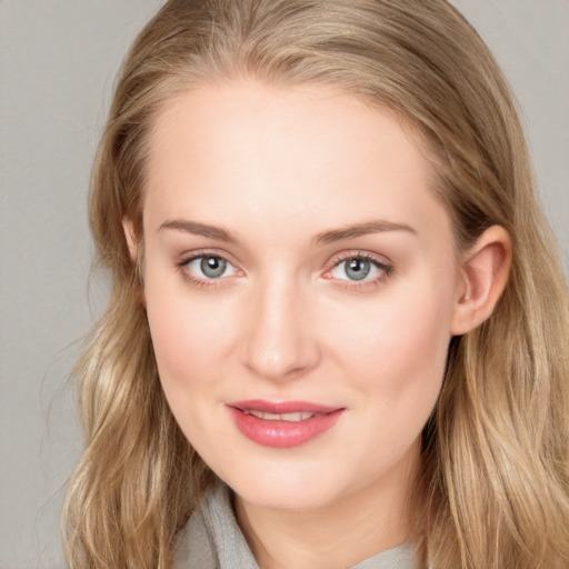 Joyful white young-adult female with long  brown hair and blue eyes