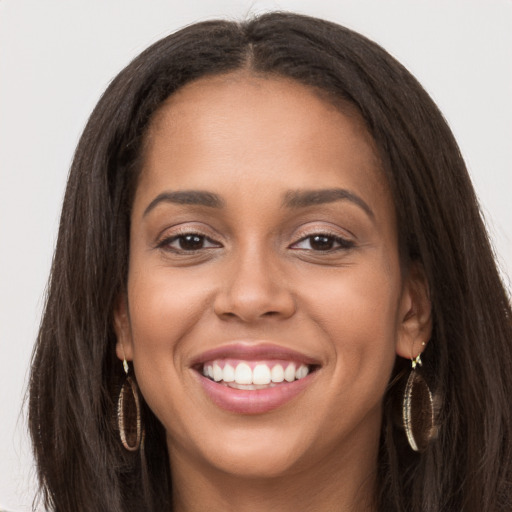 Joyful white young-adult female with long  brown hair and brown eyes