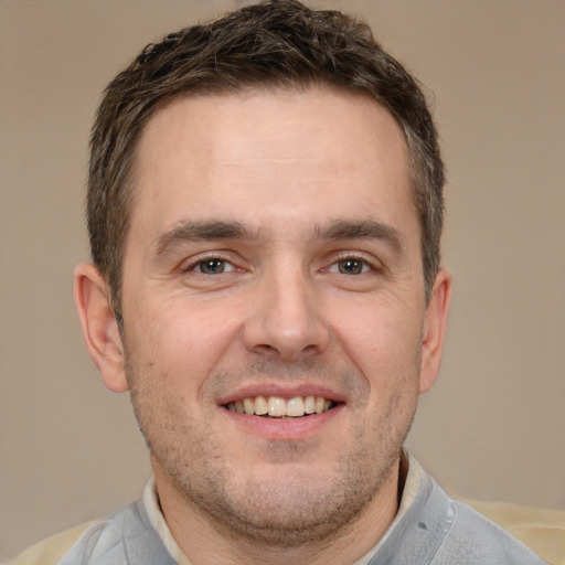 Joyful white adult male with short  brown hair and brown eyes