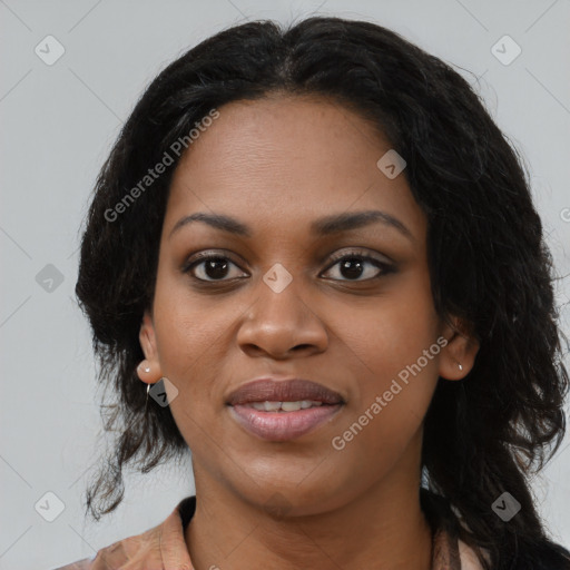 Joyful black young-adult female with long  black hair and brown eyes