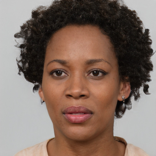 Joyful black adult female with short  black hair and brown eyes