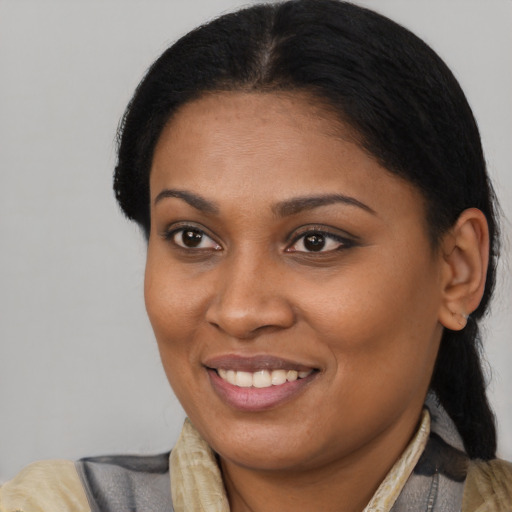 Joyful black young-adult female with short  brown hair and brown eyes