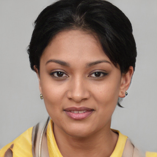 Joyful asian young-adult female with short  brown hair and brown eyes