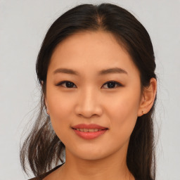 Joyful asian young-adult female with medium  brown hair and brown eyes