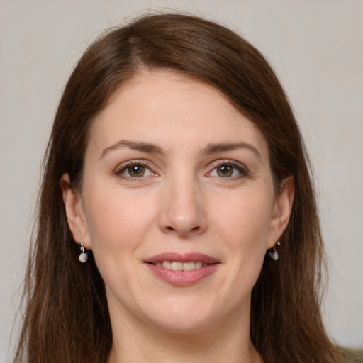 Joyful white young-adult female with long  brown hair and grey eyes