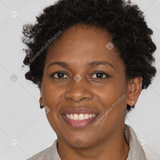 Joyful black adult female with short  brown hair and brown eyes