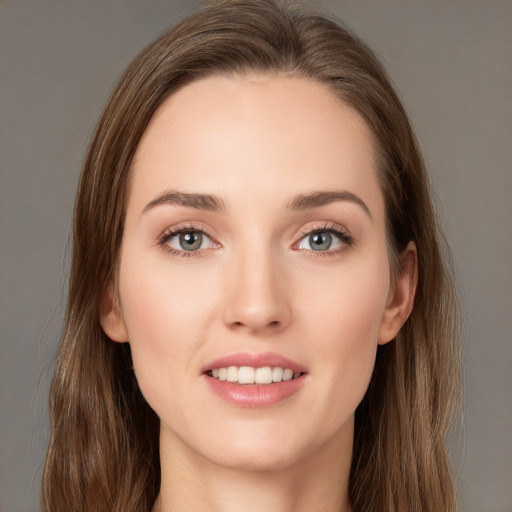 Joyful white young-adult female with long  brown hair and green eyes