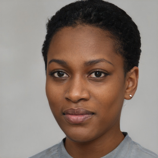 Joyful black young-adult female with short  black hair and brown eyes