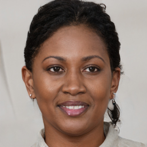Joyful black adult female with short  brown hair and brown eyes
