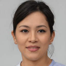 Joyful asian young-adult female with medium  brown hair and brown eyes