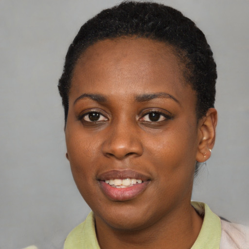 Joyful black young-adult female with short  black hair and brown eyes