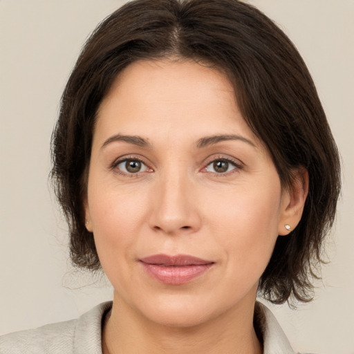 Joyful white adult female with medium  brown hair and brown eyes