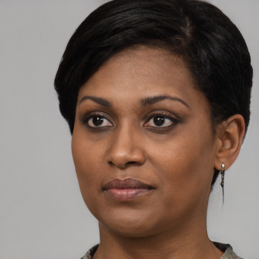 Joyful black young-adult female with medium  black hair and brown eyes