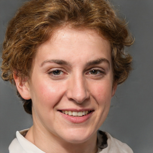 Joyful white adult female with medium  brown hair and grey eyes