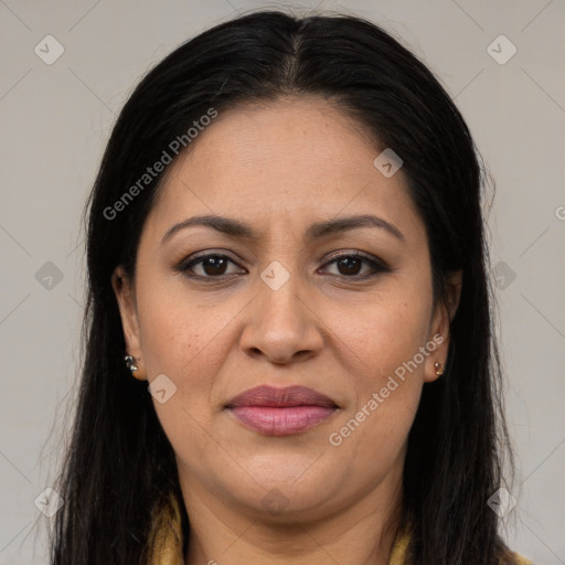 Joyful latino adult female with long  brown hair and brown eyes