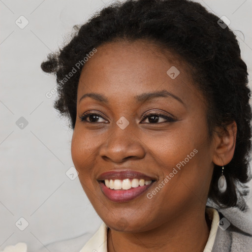 Joyful black young-adult female with long  brown hair and brown eyes