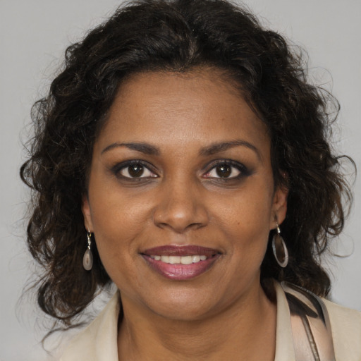 Joyful black young-adult female with medium  brown hair and brown eyes
