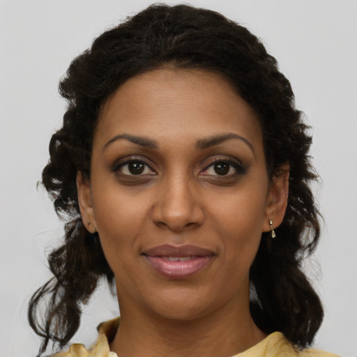 Joyful black young-adult female with medium  brown hair and brown eyes