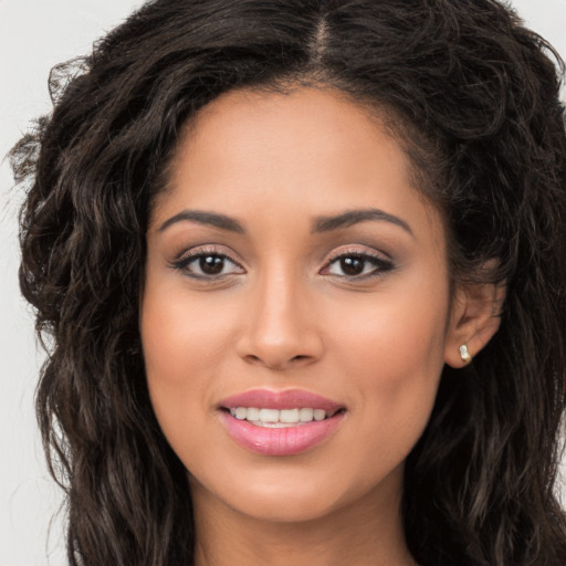 Joyful white young-adult female with long  brown hair and brown eyes