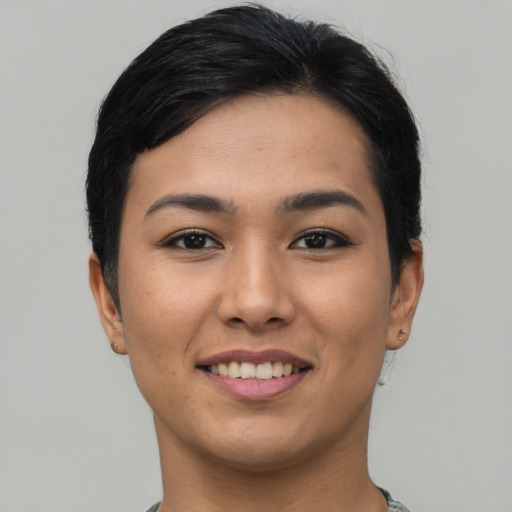 Joyful asian young-adult female with short  black hair and brown eyes