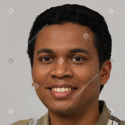 Joyful black young-adult male with short  black hair and brown eyes