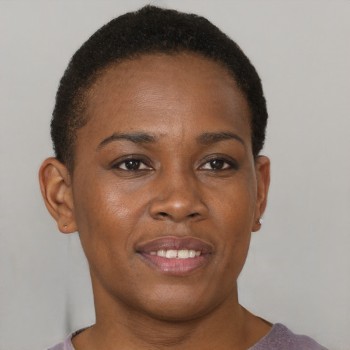 Joyful black young-adult female with short  brown hair and brown eyes