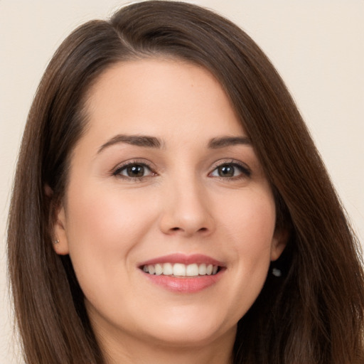 Joyful white young-adult female with long  brown hair and brown eyes