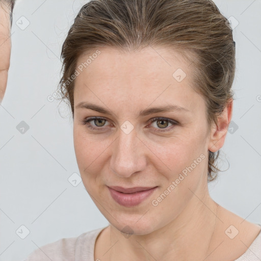 Joyful white young-adult female with medium  brown hair and grey eyes