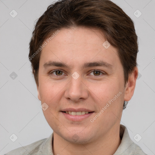 Joyful white young-adult male with short  brown hair and grey eyes